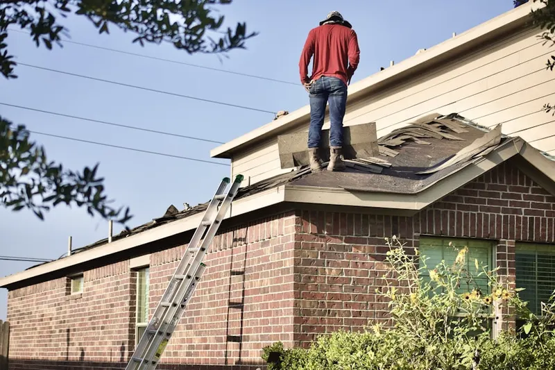 Professional roofer working on a residential roof in Maplewood